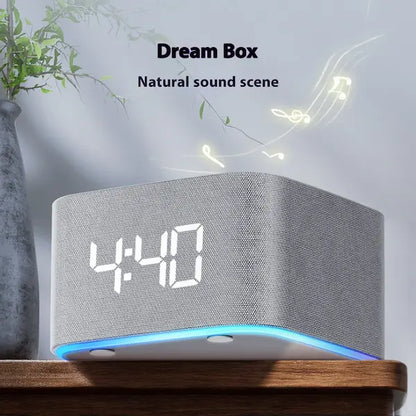 White noise sleep aid with Gray clock with digital display on a wooden surface, featuring the text 'Dream Box Natural sound scene'.